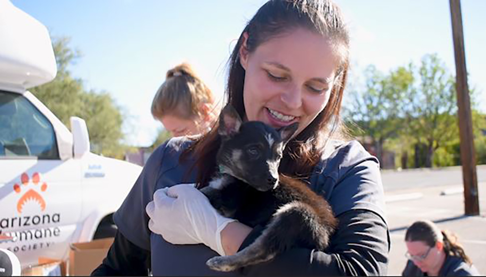 woman holding puppy